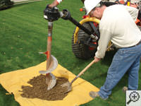 Auguring a hole in the earth for a foundation repair in La Crosse