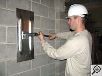Attempting to straighten a bowed foundation wall by straightening a wall anchor system in a Eden Prairie home.
