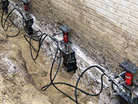 Using foundation push piers to lift a foundation during a repair in Burnsville.