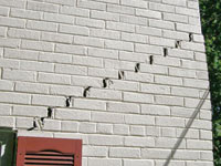 Stair-step cracks showing in a home foundation in West Fargo