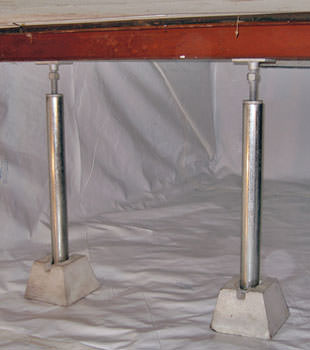 Crawl space jack posts installed in conjunction with a crawl space vapor barrier in Mason City