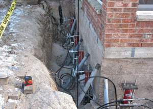 Foundation push piers installed around a house with a foundation settlement issues in Mason City