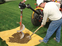Auguring a hole in the earth for a foundation wall repair system in Eden Prairie
