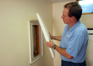 Foundation wall anchor covers installed in a finished basement with a repaired foundation wall in Mason City.