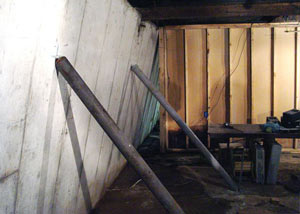 A severely tilting foundation wall propped up by steel beams in Oronoco.