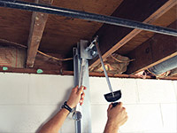 Straightening a foundation wall with the PowerBrace™ i-beam system in a Burnsville home.