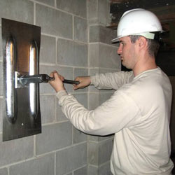 installing a wall anchor to repair an bowing foundation wall in Burnsville