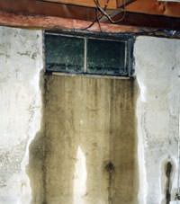 Flooding through basement windows in a Winona home.