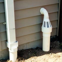 A grated sump pump discharge line fitting in West Fargo