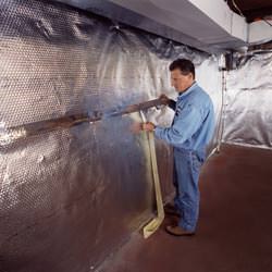 Installation of a radiant heat and vapor barrier on a basement wall in Shakopee
