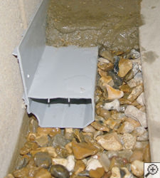 A no-clog basement french drain system installed in Eau Claire