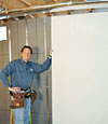 Installing wall panels on top of our basement wall insulation in Maple Grove
