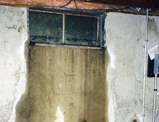 Water pouring out from a basement window in Bismarck